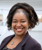 Woman with hair in ponytail smiling