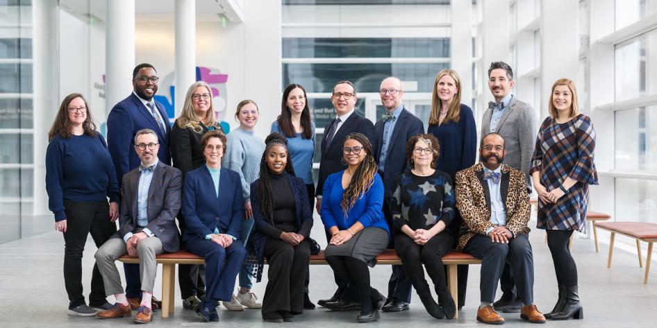 group of smiling people sitting and standing
