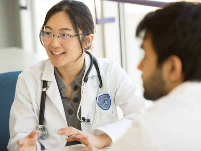 A female doctor talking with colleagues