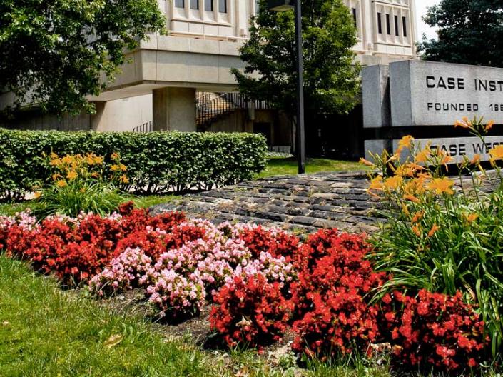 Flowers in front of Crawford Hall in the summer.