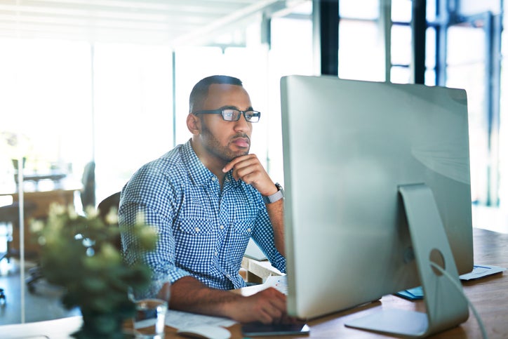 Cropped shot of a handsome young businessman working in his office