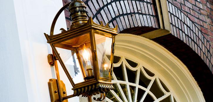 Lamp with a lightbulb on an exterior of a building