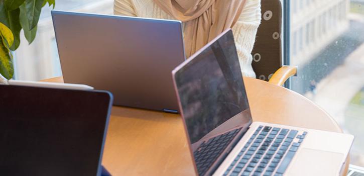 three laptop computer on a table