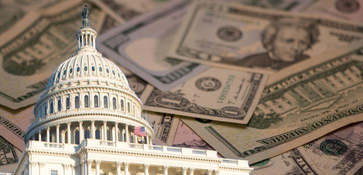 Capitol building shown with a background of paper money