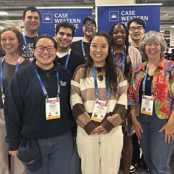 A group of nine CWRU attendees pose at the Consumer Technology Association trade show.
