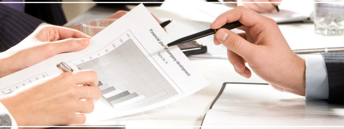 Close up of people examining a contract over a table