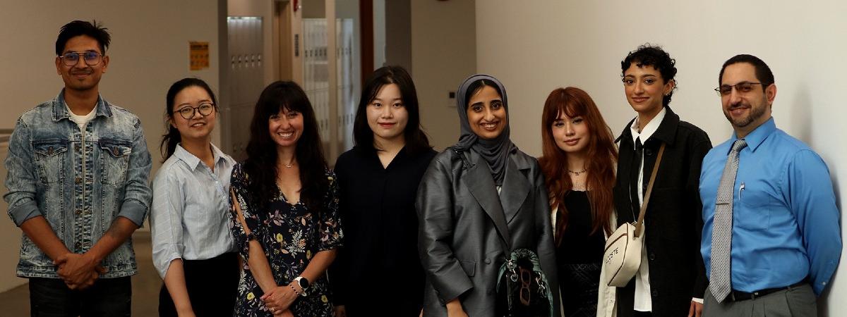 A group photo of students with their professor.