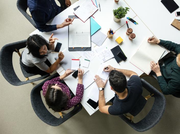 Top view shot of business colleagues discussing over a new project in office
