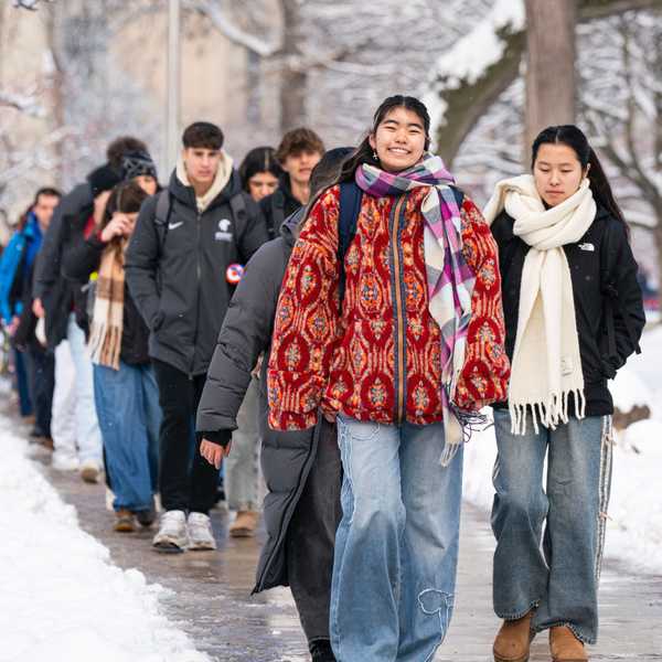 A large group of students walking through Case Quad.